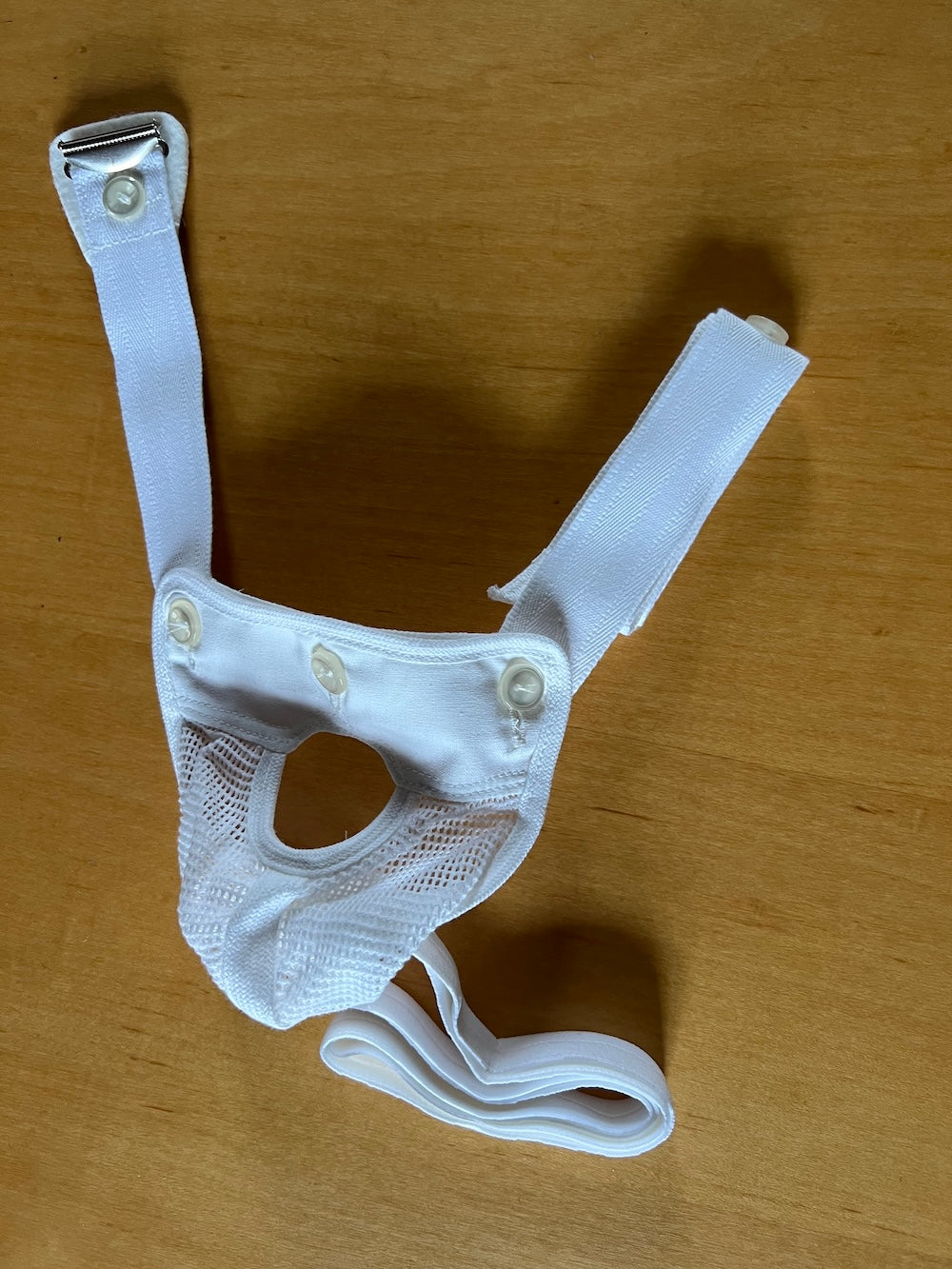 Lux testicular suspender with penis passage